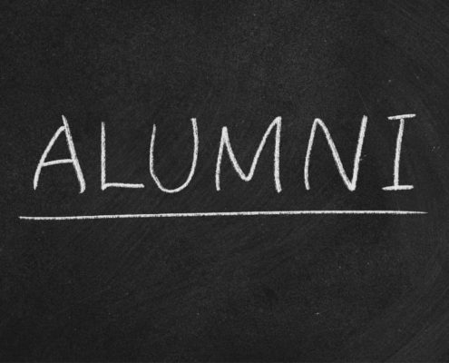 "Alumni" written on chalkboard